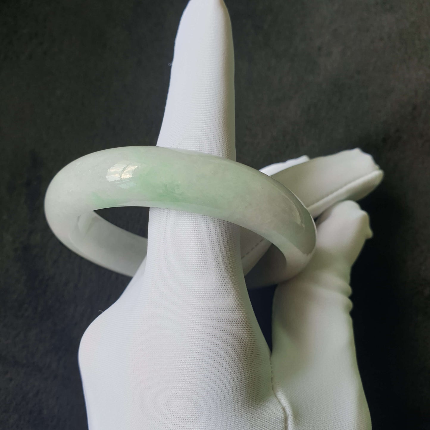 Close-up of jade bangle showing natural jade texture and translucency