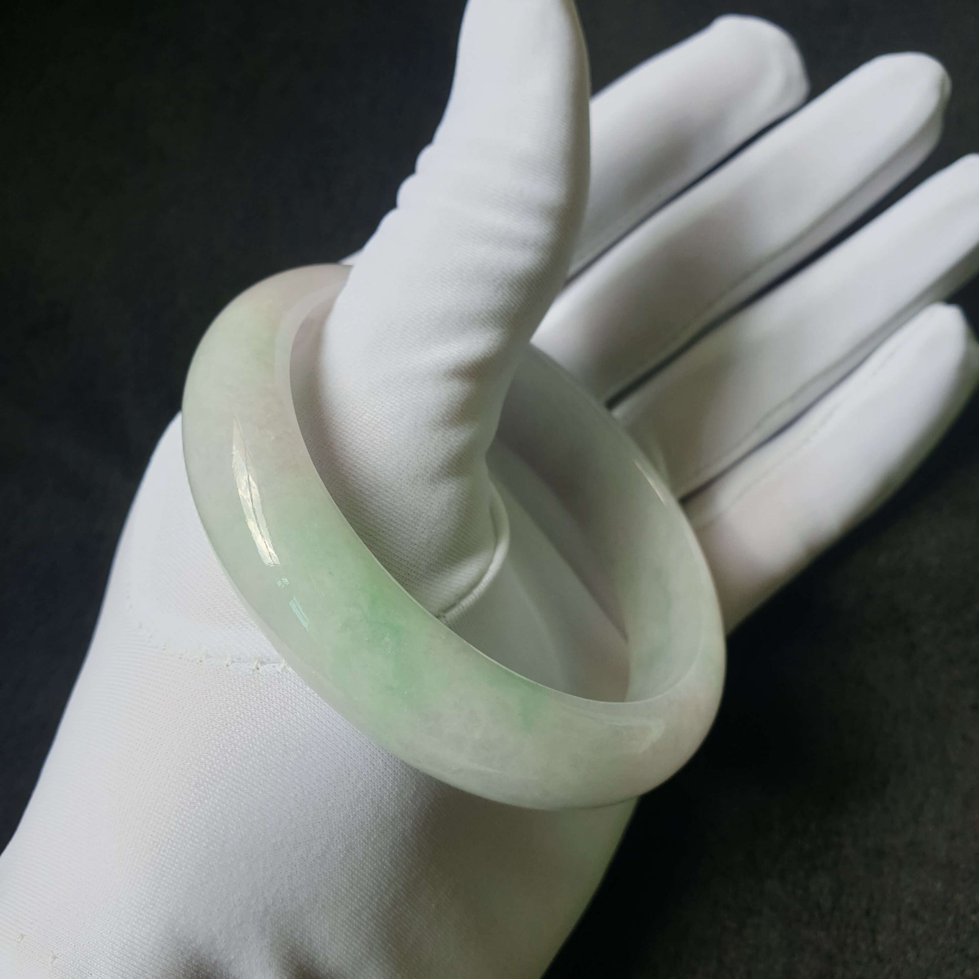 Side view of jade bangle with polished finish