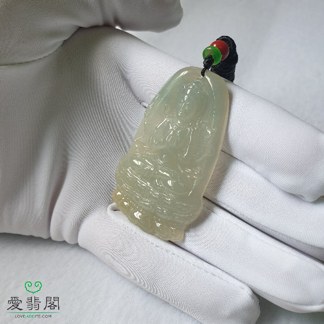Guan Yin jade pendant shown in hand for size reference